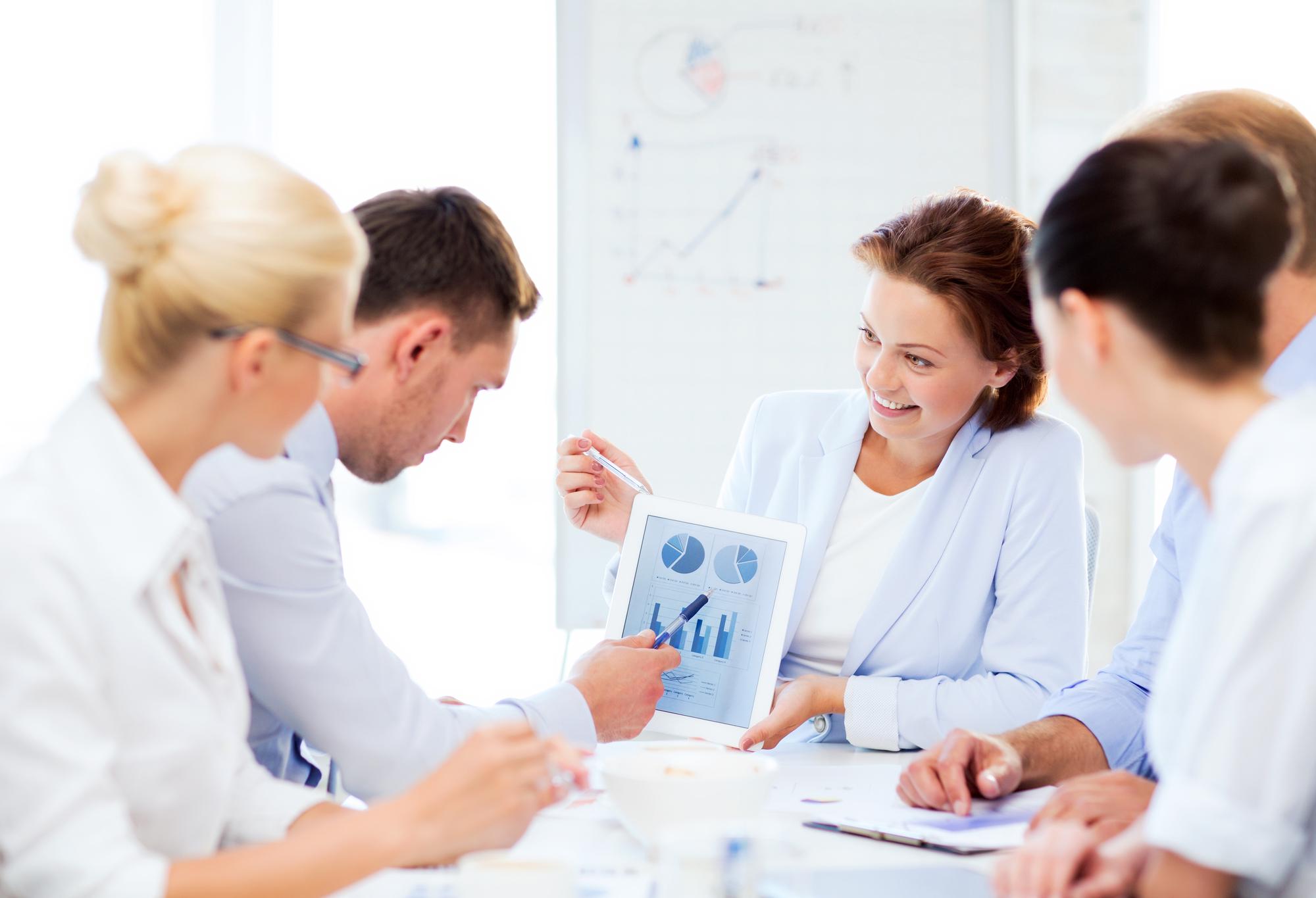 Consultant reviewing charts with client in bright office