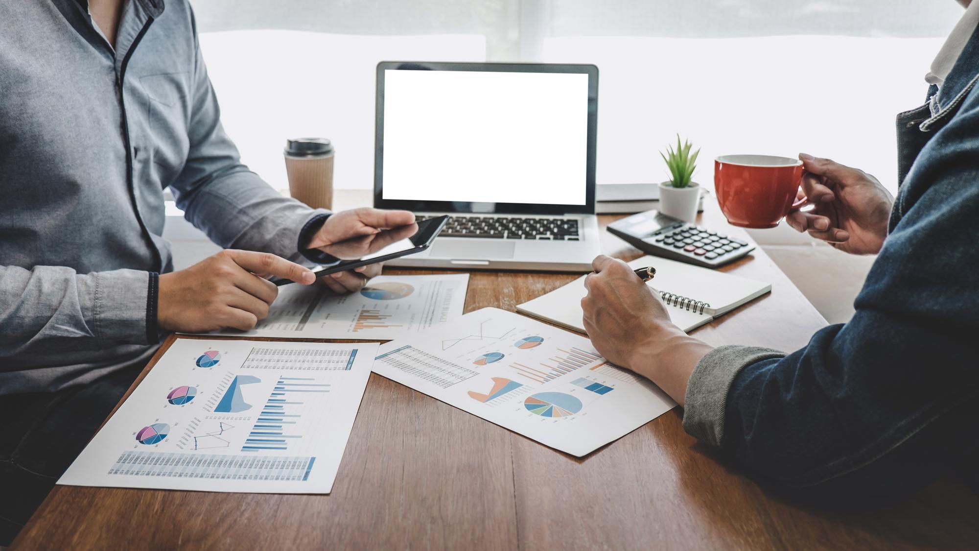Advisor discussing finances with client at a modern desk